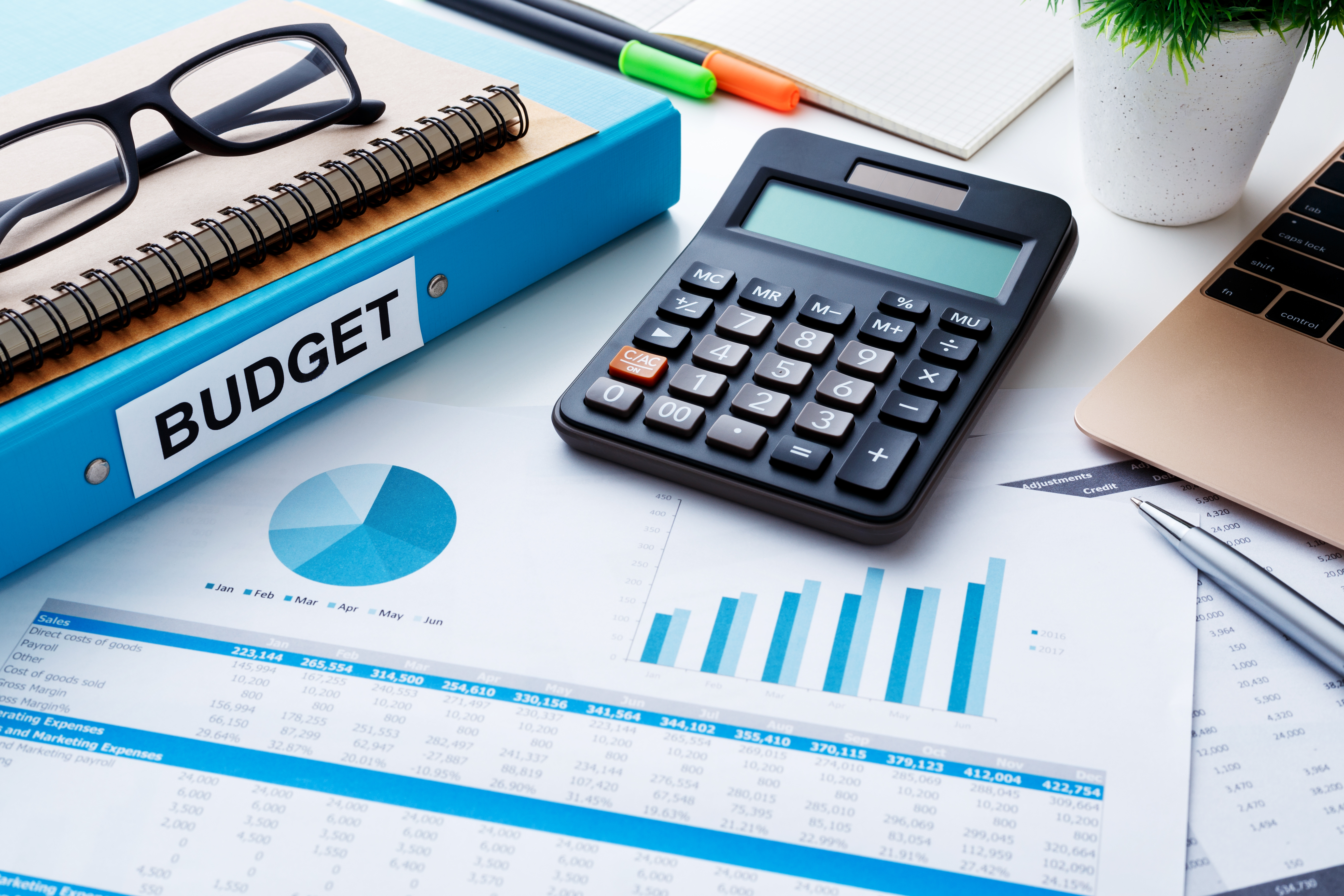 Image of calculator, Budget binder, and glasses